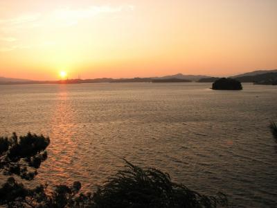 The sun setting into Omura Bay